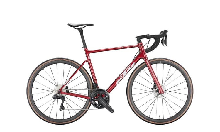 Modern 55cm KTM Revelator Alto Master road bike in matte carbon and glossy white, equipped with disc brakes.