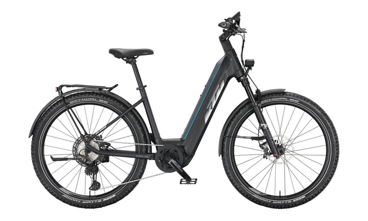 Electric bicycle with fenders, rear rack, and suspension, in black with green and purple accents.