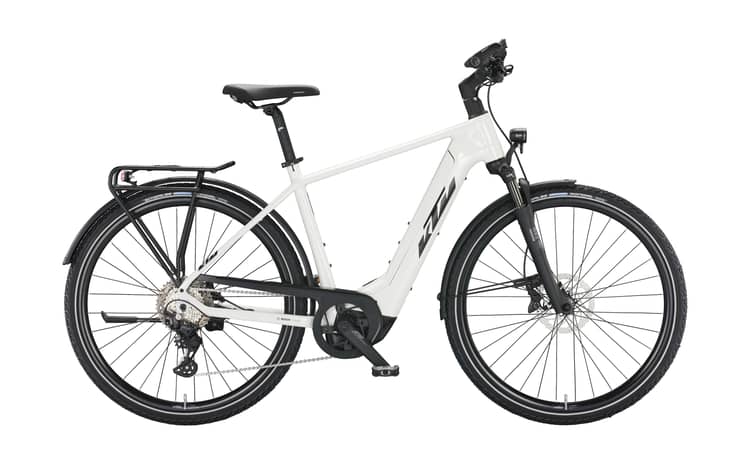 White metallic KTM Macina Sport electric bike with black and orange accents, rear rack, and Bosch motor.