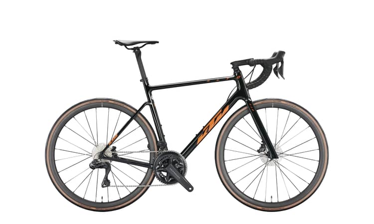 Modern 55cm KTM Revelator Alto Master road bike in matte carbon and glossy white, equipped with disc brakes.